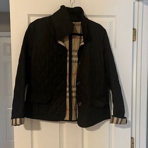 Burberry London black quilted jacket. Button front closure, collar, pockets.